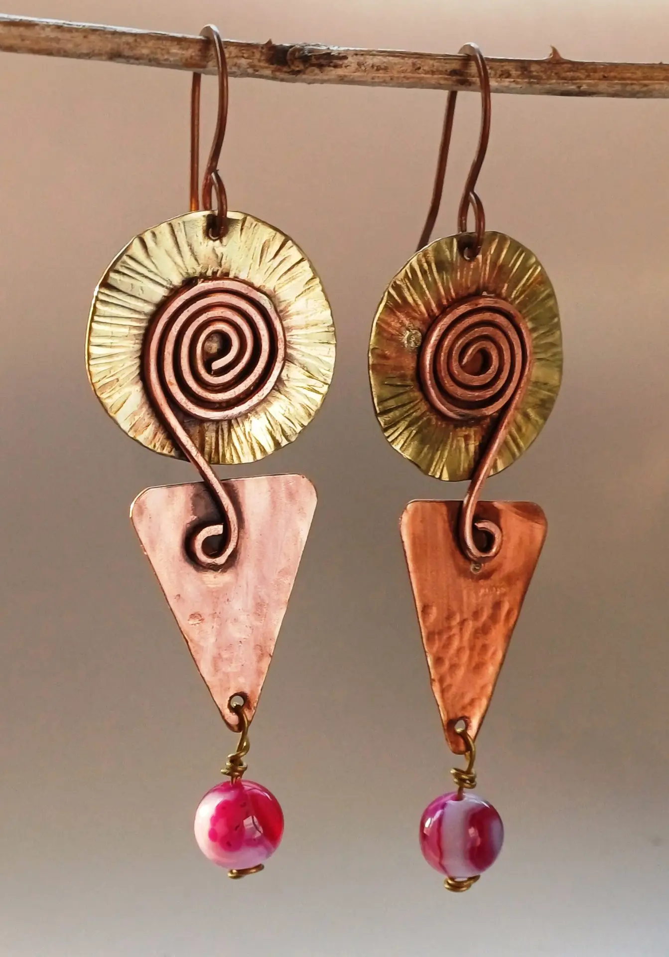 Handcrafted earrings designed with precision and artistry, featuring unique copper, silver, and brass elements. Each pair is one-of-a-kind, blending timeless elegance with sustainable fashion. Perfect for those who appreciate exclusive, artisanal jewelry.